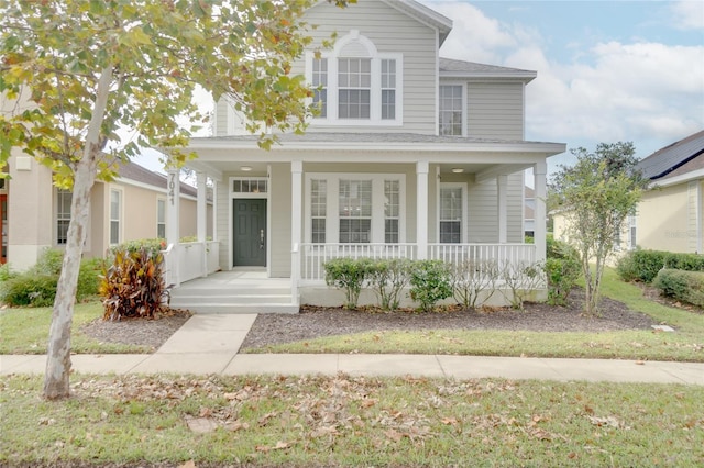 traditional home with a porch and a shingled roof