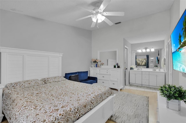 bedroom with ensuite bathroom and ceiling fan