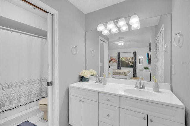 bathroom with a shower with curtain, ceiling fan, vanity, and toilet