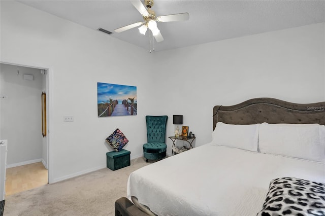 bedroom with ceiling fan and light carpet