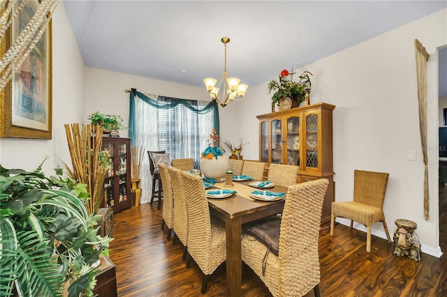 dining area with an inviting chandelier and dark hardwood / wood-style flooring