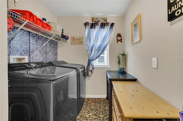 clothes washing area featuring washer and clothes dryer and tile patterned flooring