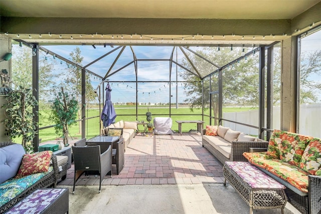 view of patio featuring outdoor lounge area and glass enclosure