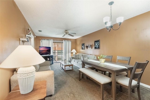 dining room featuring a textured ceiling, carpet flooring, and ceiling fan with notable chandelier