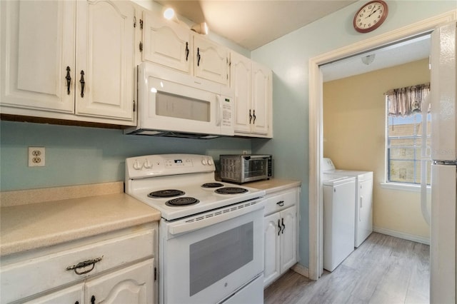 kitchen with white cabinetry, light hardwood / wood-style flooring, independent washer and dryer, and white appliances