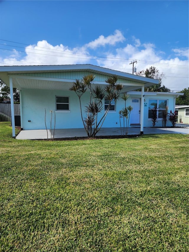 rear view of property with a yard and a porch