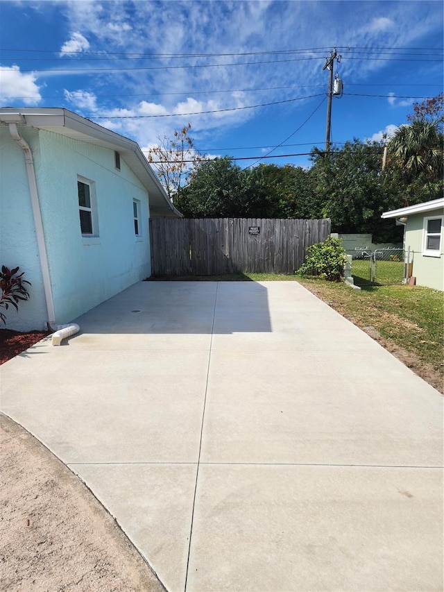 view of side of home with a patio area