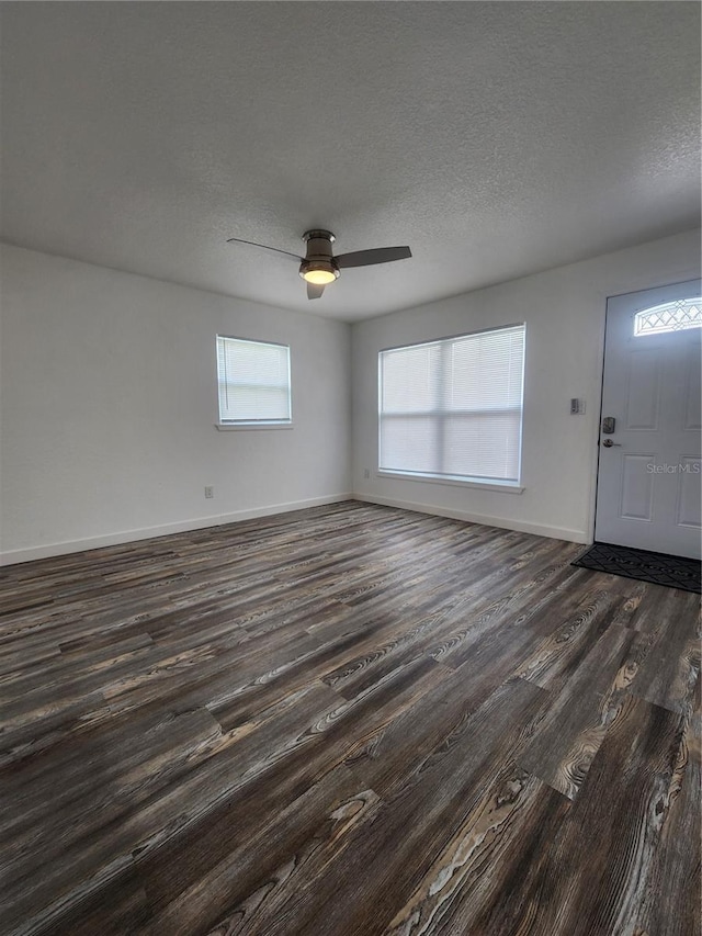 entrance foyer with dark hardwood / wood-style floors, a textured ceiling, and ceiling fan