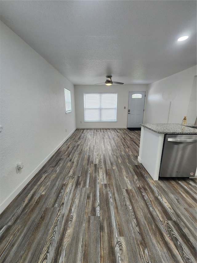 unfurnished living room featuring a textured ceiling, ceiling fan, and dark hardwood / wood-style flooring