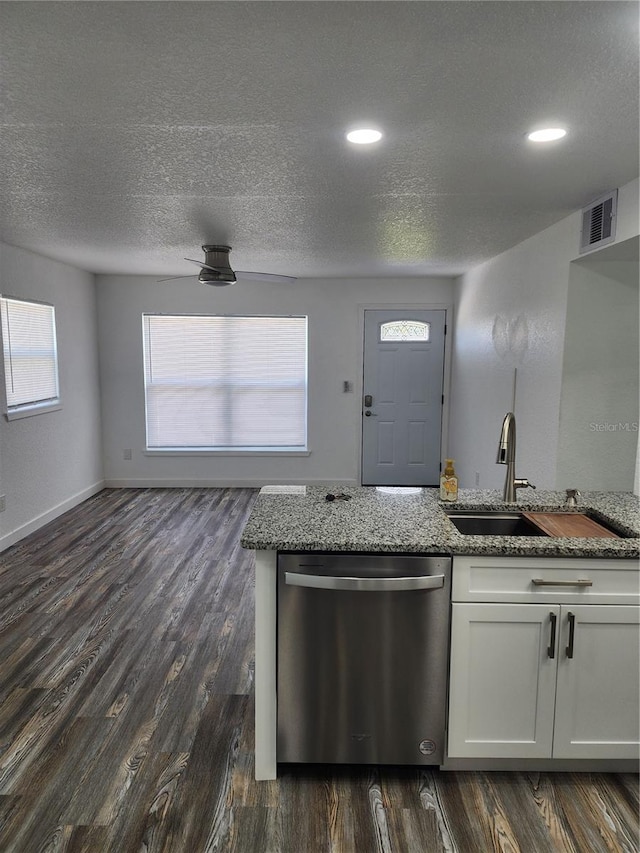 kitchen featuring white cabinetry, a wealth of natural light, dark hardwood / wood-style flooring, and stainless steel dishwasher