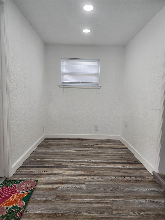 empty room with dark wood-type flooring