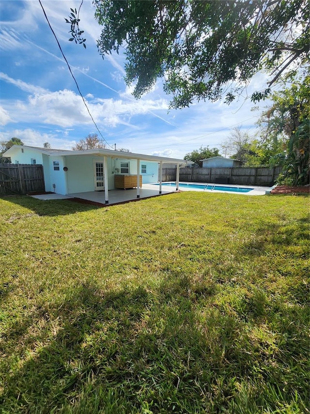 view of yard featuring a fenced in pool and a patio