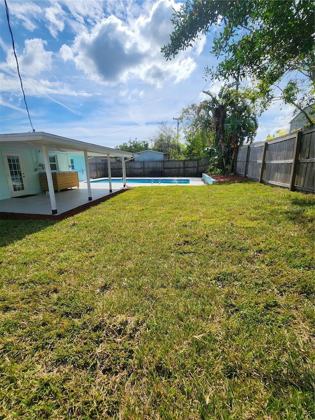 view of yard featuring a patio and a fenced in pool