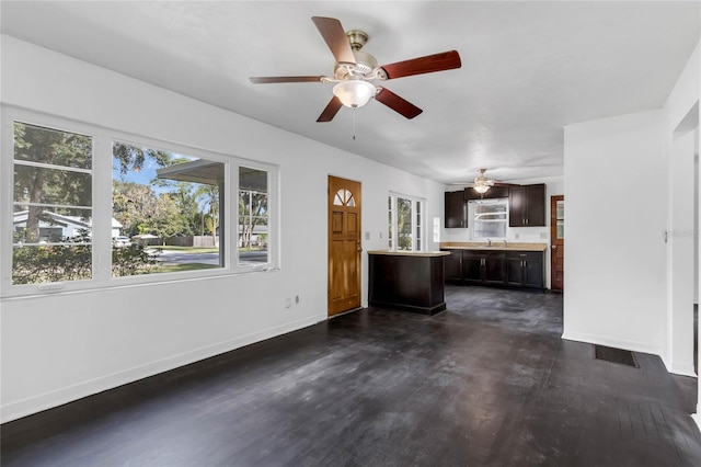 unfurnished living room with sink and dark hardwood / wood-style flooring