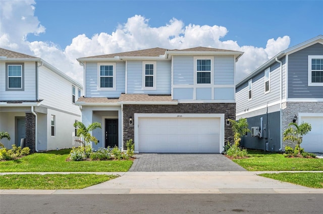 view of front facade with a front yard and a garage