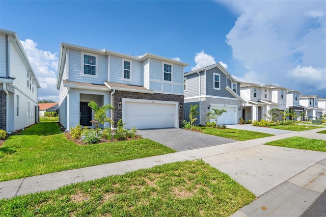 multi unit property with a front yard and a garage