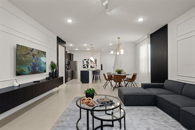 living room with light tile patterned flooring and a chandelier