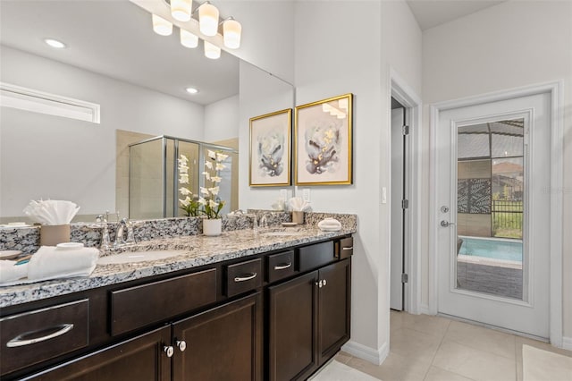 bathroom featuring vanity, tile patterned floors, and walk in shower