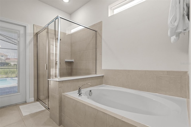 bathroom featuring tile patterned floors and shower with separate bathtub