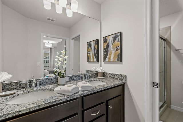 bathroom featuring vanity, walk in shower, and tile patterned flooring