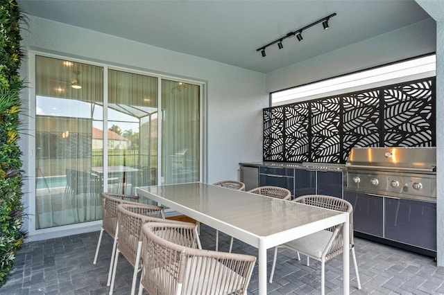 dining room featuring rail lighting and plenty of natural light