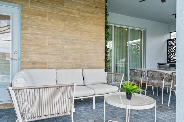 view of patio featuring ceiling fan and an outdoor living space