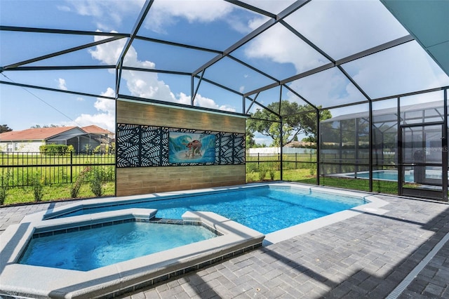 view of swimming pool featuring an in ground hot tub, a patio area, and a lanai