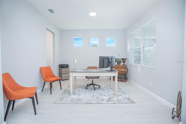 office space featuring a wealth of natural light and light wood-type flooring