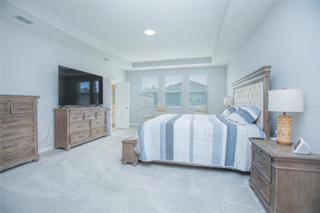 bedroom featuring a tray ceiling and carpet flooring