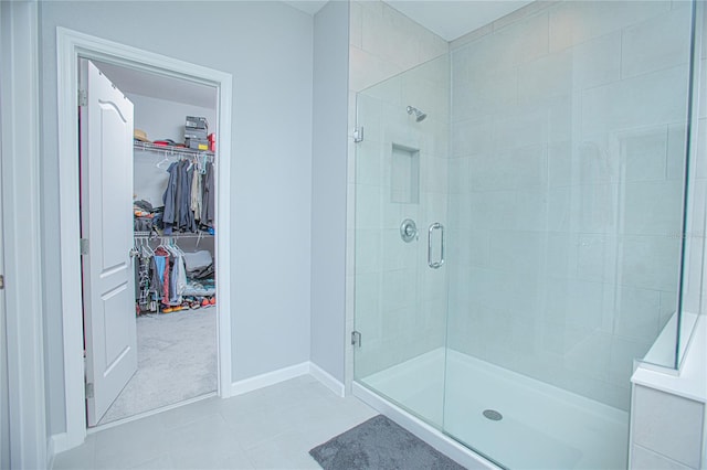 bathroom with tile patterned floors and an enclosed shower