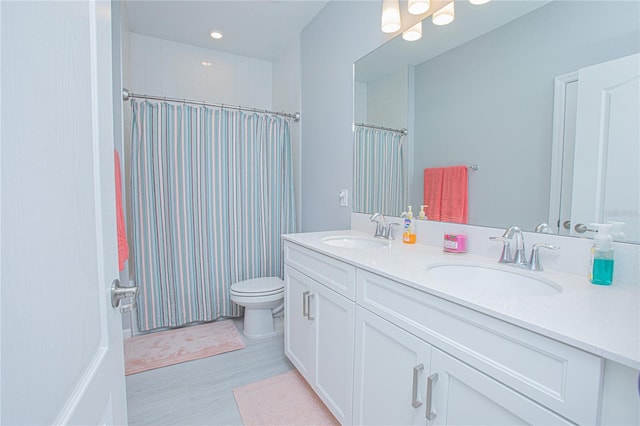 bathroom featuring vanity, toilet, walk in shower, and wood-type flooring