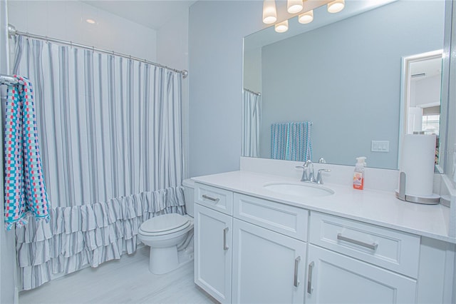 bathroom featuring vanity, toilet, and a shower with shower curtain