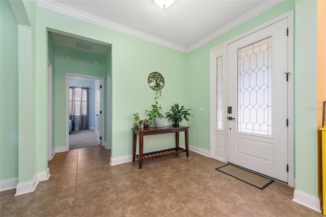 tiled foyer with ornamental molding