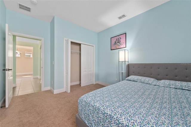 bedroom with light colored carpet and a closet