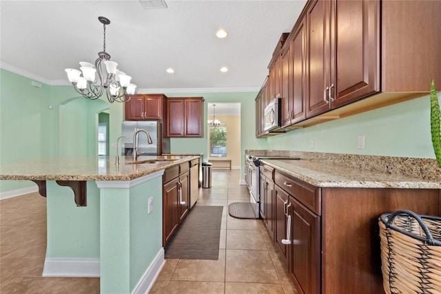 kitchen featuring hanging light fixtures, stainless steel appliances, ornamental molding, sink, and light tile patterned flooring