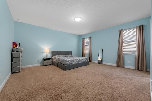 carpeted bedroom featuring a textured ceiling