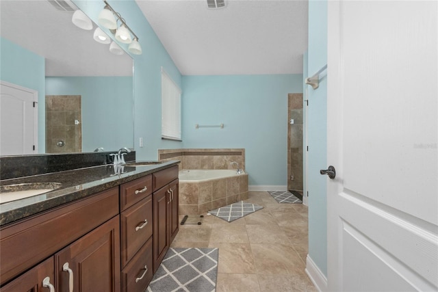 bathroom featuring vanity, plus walk in shower, and tile patterned floors