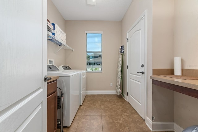 laundry area featuring washer and dryer and light tile patterned floors