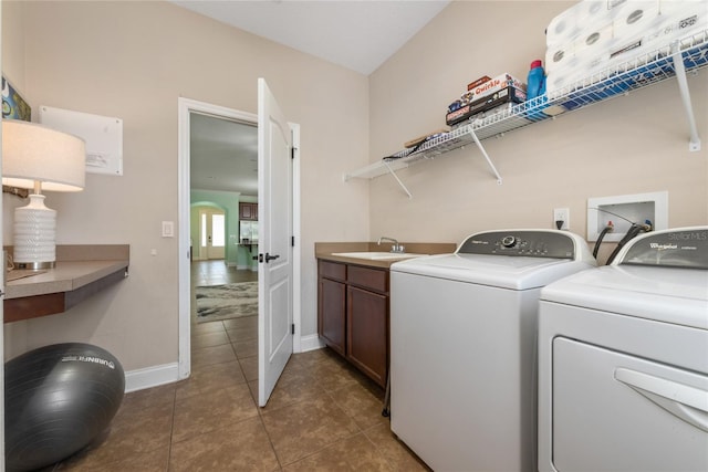 laundry room featuring cabinets, sink, tile patterned floors, and washing machine and dryer