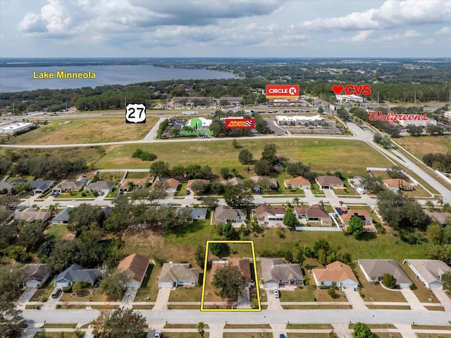 drone / aerial view with a residential view and a water view