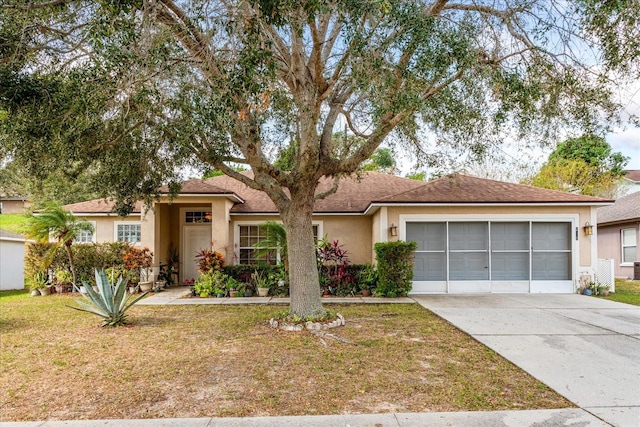 ranch-style house with a garage and a front lawn