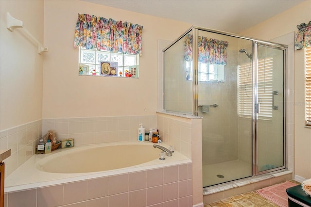 bathroom featuring vanity, plenty of natural light, and plus walk in shower