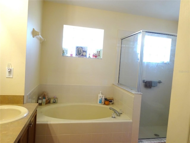 bathroom with vanity and separate shower and tub