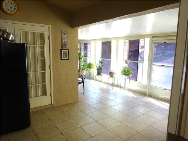 tiled empty room with a wealth of natural light