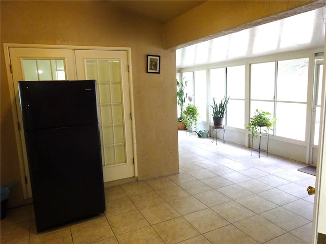 721 Willow Run St, Minneola, FL 34715 - kitchen with freestanding refrigerator and light tile patterned floors
