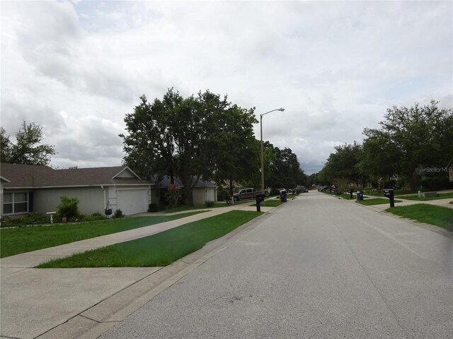 721 Willow Run St, Minneola, FL 34715 - view of asphalt street with street lighting and sidewalks