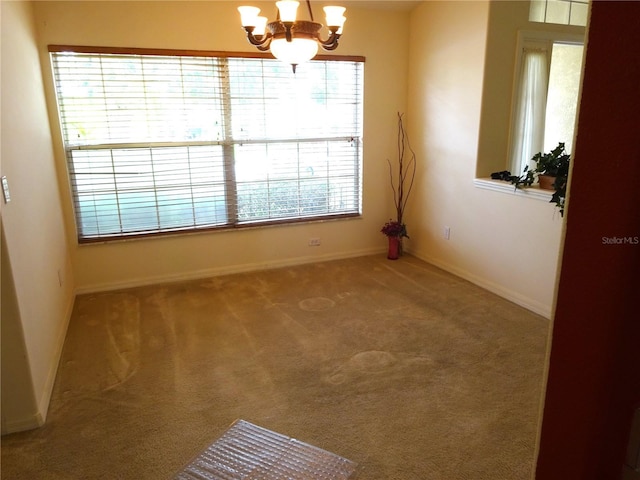 721 Willow Run St, Minneola, FL 34715 - empty room featuring a chandelier, carpet flooring, and baseboards