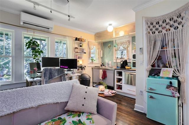 interior space featuring ornamental molding, rail lighting, an AC wall unit, and dark hardwood / wood-style floors