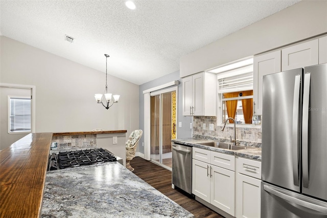 kitchen with butcher block countertops, white cabinetry, stainless steel appliances, and dark hardwood / wood-style floors