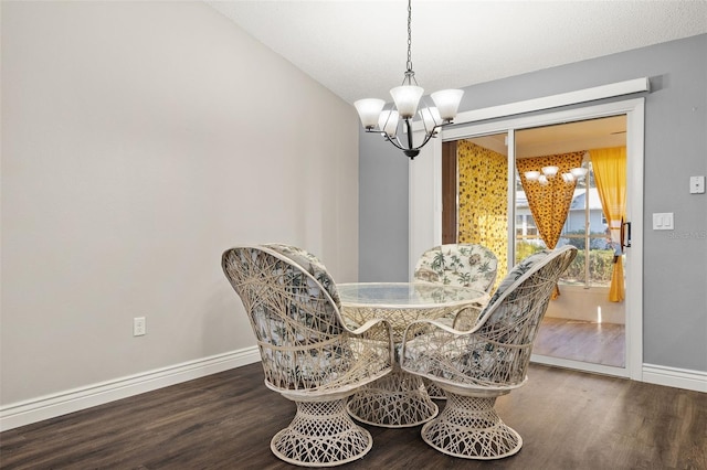 dining room featuring an inviting chandelier and hardwood / wood-style flooring